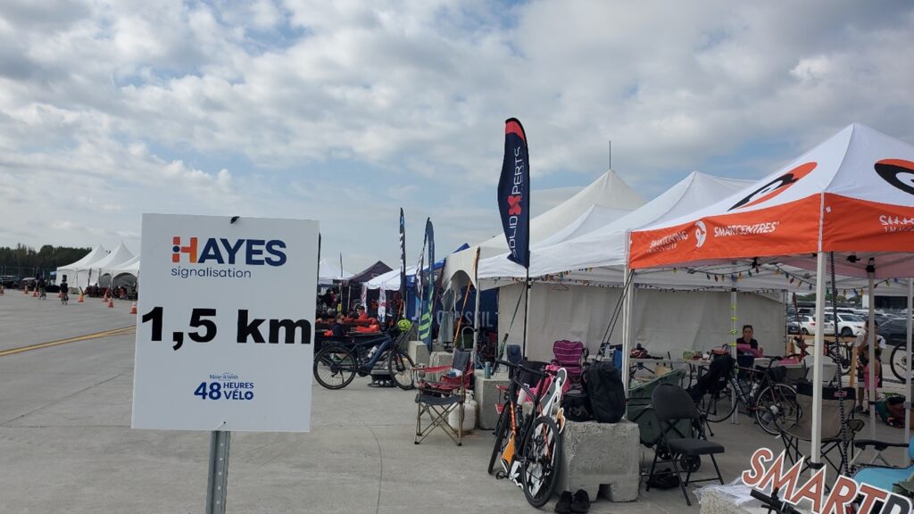 Bikes, team flags, and tents lined up along side the ICAR racetrack the Make-a-Wish 48-Hour Bike Ride.